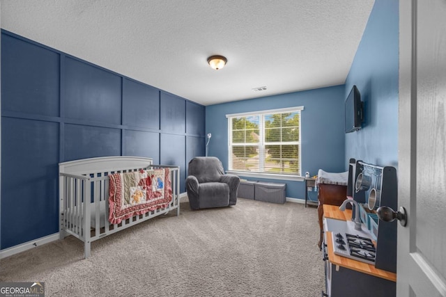 89 Crestview Dr, Guyton, GA 31312 - carpeted bedroom featuring a crib and a textured ceiling