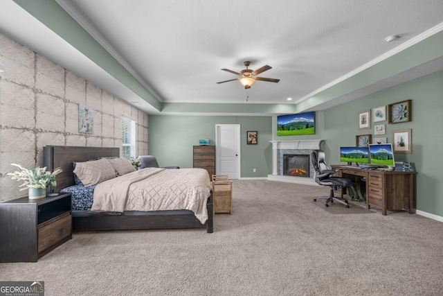 89 Crestview Dr, Guyton, GA 31312 - bedroom featuring a glass covered fireplace, carpet flooring, ornamental molding, a desk, and a tray ceiling