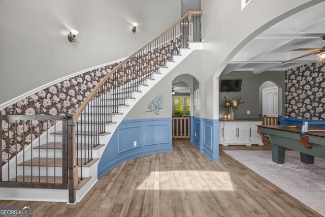 89 Crestview Dr, Guyton, GA 31312 - stairway featuring a ceiling fan, wood finished floors, coffered ceiling, beam ceiling, and arched walkways