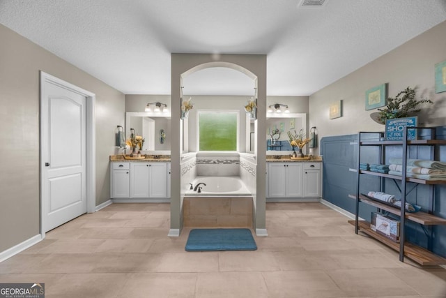 89 Crestview Dr, Guyton, GA 31312 - full bathroom featuring two vanities, a bath, a textured ceiling, and tile patterned flooring