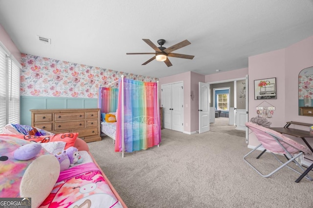 89 Crestview Dr, Guyton, GA 31312 - carpeted bedroom featuring wallpapered walls, multiple windows, wainscoting, and ceiling fan