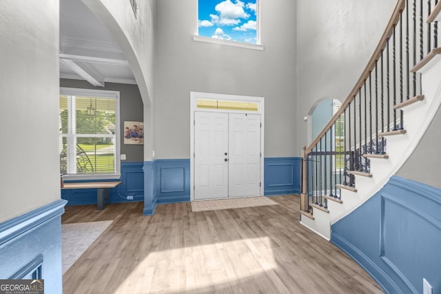 89 Crestview Dr, Guyton, GA 31312 - entrance foyer featuring arched walkways, wood finished floors, a towering ceiling, stairs, and ornamental molding