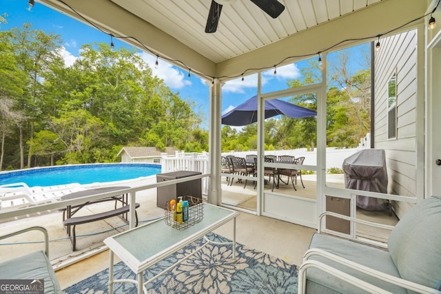 89 Crestview Dr, Guyton, GA 31312 - sunroom featuring ceiling fan, view of scattered trees, and outdoor dining area