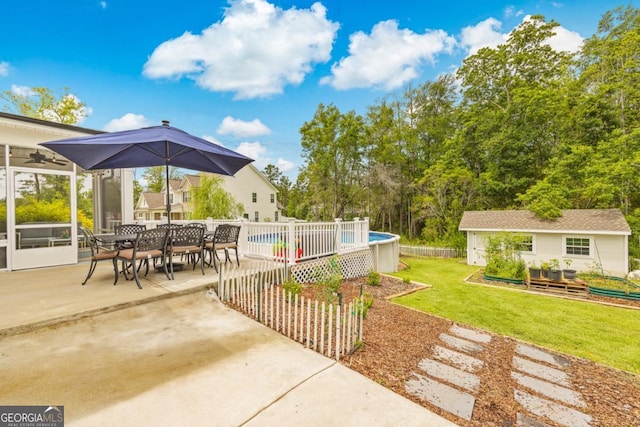 89 Crestview Dr, Guyton, GA 31312 - view of green lawn featuring outdoor dining space, a ceiling fan, a patio area, an outdoor structure, and a wooden deck