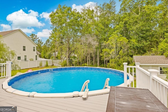 89 Crestview Dr, Guyton, GA 31312 - view of pool with a wooden deck and view of wooded area