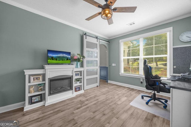 89 Crestview Dr, Guyton, GA 31312 - office space featuring ornamental molding, wood finished floors, ceiling fan, a barn door, and a glass covered fireplace