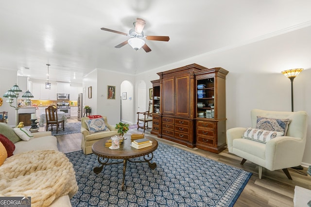58 Lilyfield Ln, Acworth, GA 30101 - living area with wood finished floors, ceiling fan, arched walkways, and crown molding