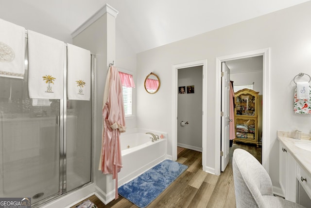 58 Lilyfield Ln, Acworth, GA 30101 - full bathroom featuring wood finished floors, a bath, a shower stall, vanity, and lofted ceiling