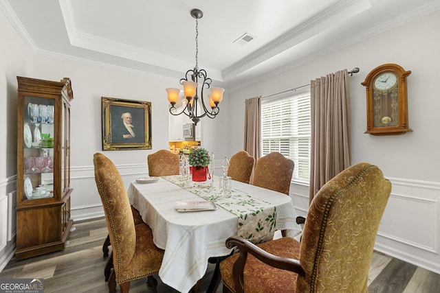 58 Lilyfield Ln, Acworth, GA 30101 - dining room featuring a raised ceiling, a chandelier, wood finished floors, ornamental molding, and a decorative wall