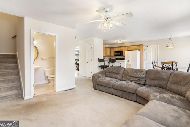 8810 Brookhurst Trl, Gainesville, GA 30506 - living room featuring light colored carpet, stairs, and a ceiling fan