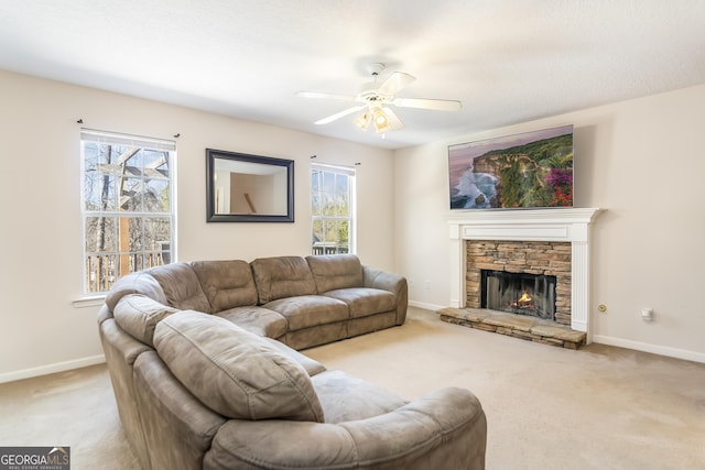 8810 Brookhurst Trl, Gainesville, GA 30506 - carpeted living area with a ceiling fan and a stone fireplace