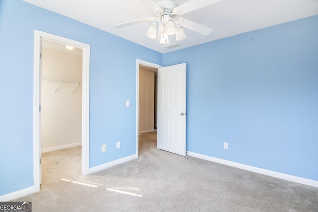 8810 Brookhurst Trl, Gainesville, GA 30506 - unfurnished bedroom with a walk in closet, carpet, a closet, and a ceiling fan