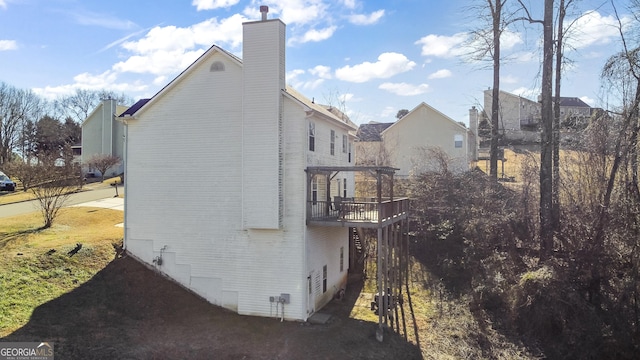 8810 Brookhurst Trl, Gainesville, GA 30506 - view of property exterior with a chimney, a wooden deck, and brick siding