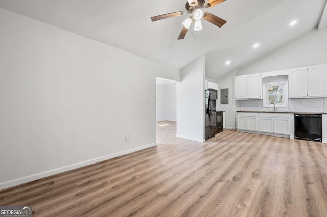 5153 Westbrook Pl, Union City, GA 30291 - unfurnished living room featuring lofted ceiling, light wood-style flooring, a ceiling fan, recessed lighting, and electric panel