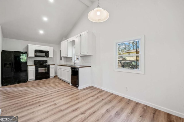 5153 Westbrook Pl, Union City, GA 30291 - kitchen with black appliances, white cabinetry, light wood-style floors, decorative backsplash, and high vaulted ceiling