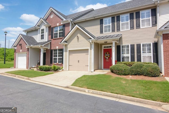 2557 Avery Park Cir, Atlanta, GA 30360 - view of front of house featuring brick siding, concrete driveway, an attached garage, and a standing seam roof