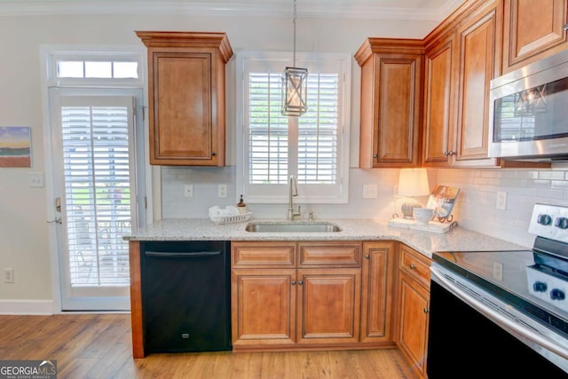 2557 Avery Park Cir, Atlanta, GA 30360 - kitchen featuring appliances with stainless steel finishes, brown cabinetry, backsplash, light stone counters, and ornamental molding