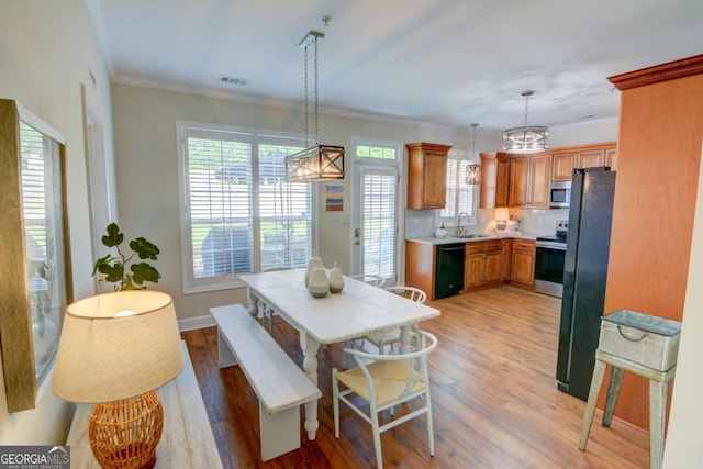 2557 Avery Park Cir, Atlanta, GA 30360 - dining space featuring a chandelier, light wood-type flooring, and ornamental molding