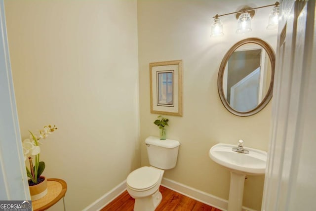 2557 Avery Park Cir, Atlanta, GA 30360 - half bathroom featuring wood finished floors and toilet