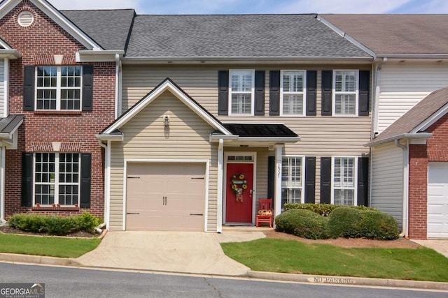 2557 Avery Park Cir, Atlanta, GA 30360 - view of property featuring a garage, driveway, a shingled roof, and brick siding