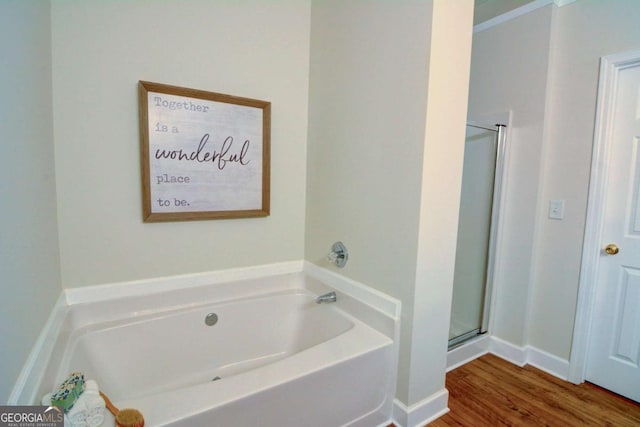 2557 Avery Park Cir, Atlanta, GA 30360 - full bath featuring a bath, a stall shower, and wood finished floors