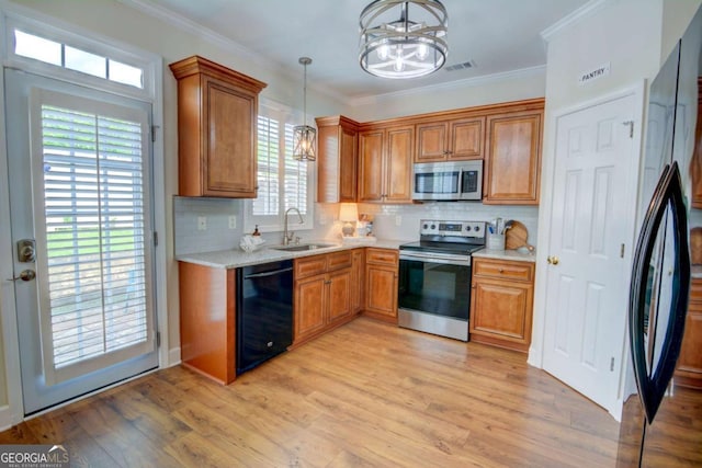 2557 Avery Park Cir, Atlanta, GA 30360 - kitchen featuring black appliances, a chandelier, tasteful backsplash, brown cabinetry, and plenty of natural light