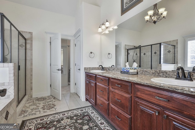 118 Fire Creek Trl, Senoia, GA 30276 - bathroom featuring a shower stall, double vanity, tile patterned floors, and a chandelier