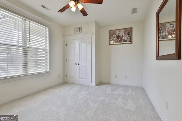 118 Fire Creek Trl, Senoia, GA 30276 - unfurnished bedroom featuring light colored carpet, ceiling fan, and a closet
