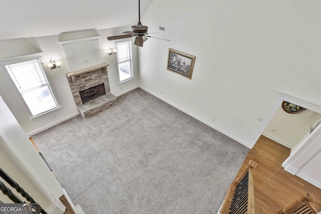 118 Fire Creek Trl, Senoia, GA 30276 - unfurnished living room with a stone fireplace, a ceiling fan, and wood finished floors