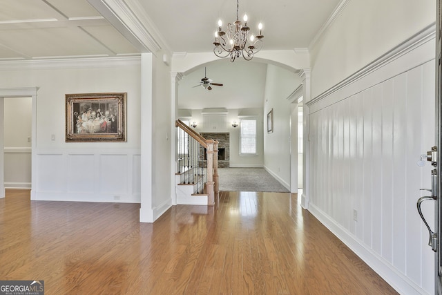 118 Fire Creek Trl, Senoia, GA 30276 - foyer featuring a ceiling fan, arched walkways, crown molding, stairs, and wood finished floors