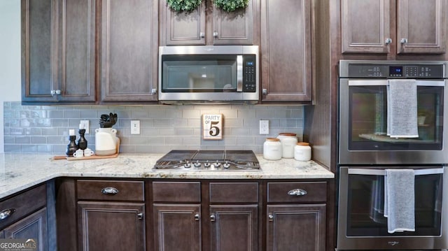 8325 Post Oak Ln, Gainesville, GA 30506 - kitchen with appliances with stainless steel finishes, dark brown cabinets, and decorative backsplash