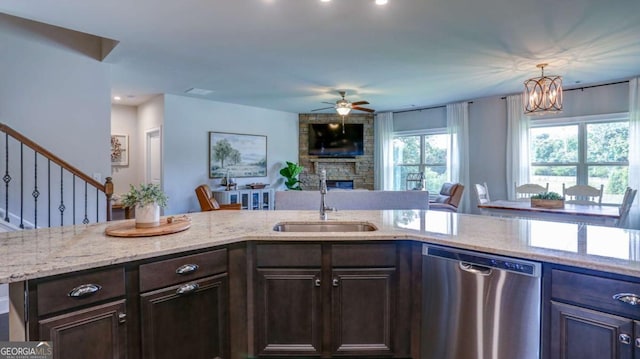 8325 Post Oak Ln, Gainesville, GA 30506 - kitchen with stainless steel dishwasher, a stone fireplace, a ceiling fan, open floor plan, and light stone countertops