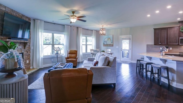 8325 Post Oak Ln, Gainesville, GA 30506 - living room featuring a ceiling fan, a stone fireplace, dark wood-style flooring, recessed lighting, and a chandelier