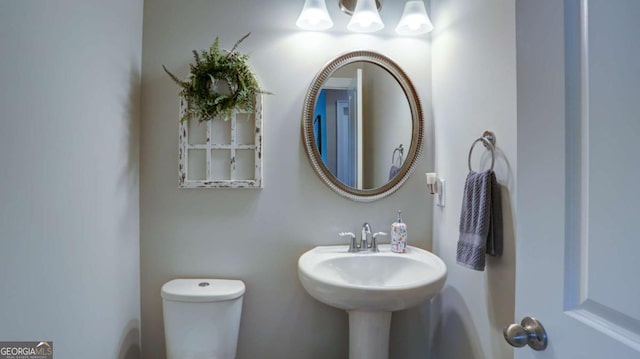 8325 Post Oak Ln, Gainesville, GA 30506 - half bath with toilet and a chandelier