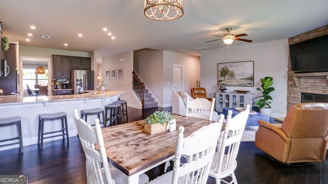 8325 Post Oak Ln, Gainesville, GA 30506 - dining room featuring dark wood-style flooring, stairs, a ceiling fan, recessed lighting, and a stone fireplace