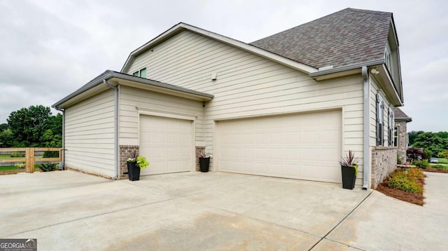 8325 Post Oak Ln, Gainesville, GA 30506 - view of side of home featuring brick siding, concrete driveway, an attached garage, and roof with shingles