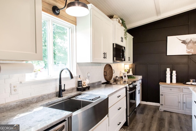 313 White Pine Highway, Nicholls, GA 31554 - kitchen featuring appliances with stainless steel finishes, white cabinets, tasteful backsplash, dark wood-type flooring, and light stone counters