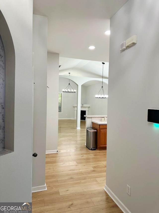 6834 White Walnut Way, Braselton, GA 30517 - corridor featuring arched walkways, a chandelier, light wood-style flooring, recessed lighting, and vaulted ceiling