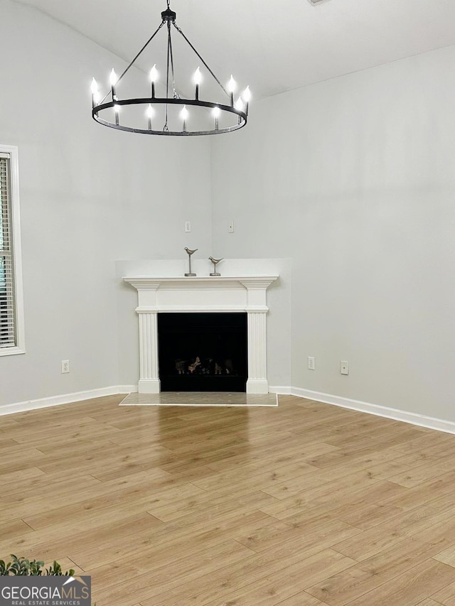 6834 White Walnut Way, Braselton, GA 30517 - unfurnished living room featuring light wood-style floors, a chandelier, high vaulted ceiling, and a fireplace