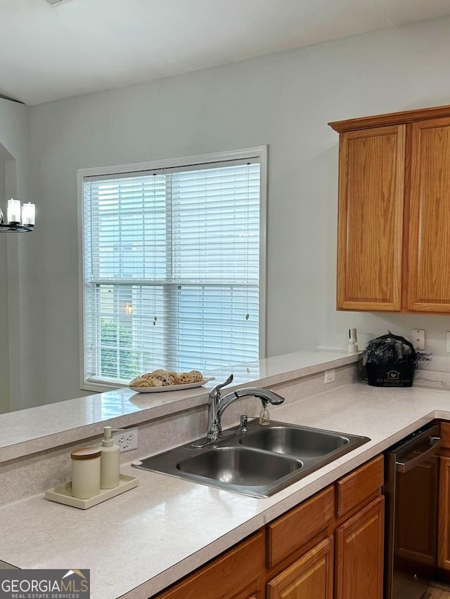 6834 White Walnut Way, Braselton, GA 30517 - kitchen featuring stainless steel dishwasher, light countertops, and brown cabinetry