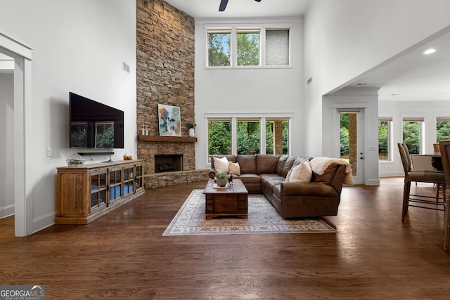 150 Dean Dr, Tyrone, GA 30290 - living area with a ceiling fan, healthy amount of natural light, a fireplace, a towering ceiling, and wood finished floors