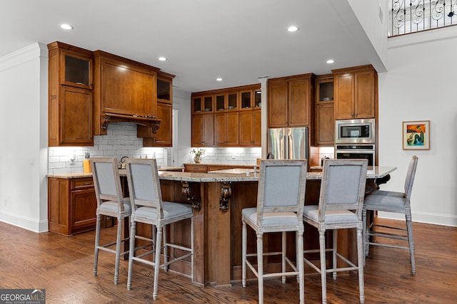 150 Dean Dr, Tyrone, GA 30290 - kitchen with appliances with stainless steel finishes, brown cabinets, recessed lighting, tasteful backsplash, and glass insert cabinets