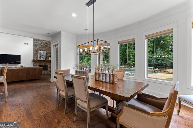150 Dean Dr, Tyrone, GA 30290 - dining space featuring ornamental molding, dark wood-style flooring, a chandelier, a fireplace, and recessed lighting