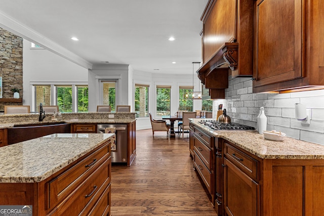 150 Dean Dr, Tyrone, GA 30290 - kitchen featuring appliances with stainless steel finishes, light stone counters, dark wood finished floors, decorative backsplash, and crown molding