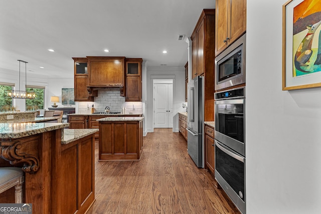 150 Dean Dr, Tyrone, GA 30290 - kitchen with appliances with stainless steel finishes, dark wood-style floors, glass insert cabinets, backsplash, and recessed lighting