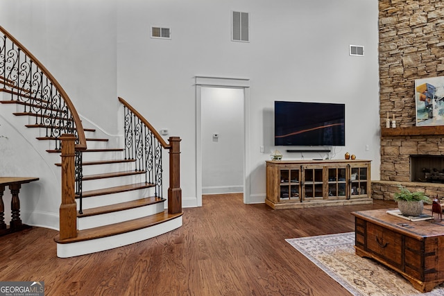 150 Dean Dr, Tyrone, GA 30290 - living area featuring a towering ceiling, wood finished floors, stairs, and a stone fireplace