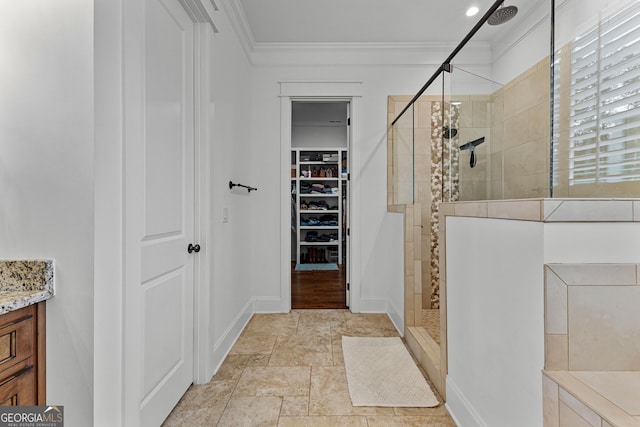 150 Dean Dr, Tyrone, GA 30290 - bathroom with tiled shower, ornamental molding, vanity, and a walk in closet