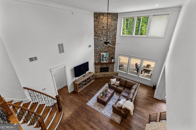 150 Dean Dr, Tyrone, GA 30290 - living room with wood finished floors, a stone fireplace, ceiling fan, and stairs