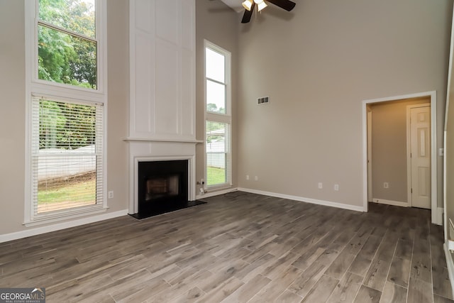 2801 Priestcliff Dr, Smyrna, GA 30080 - unfurnished living room featuring a high ceiling, ceiling fan, wood finished floors, and a fireplace