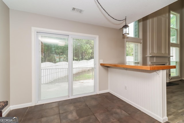 2801 Priestcliff Dr, Smyrna, GA 30080 - kitchen featuring a breakfast bar area, butcher block countertops, and pendant lighting